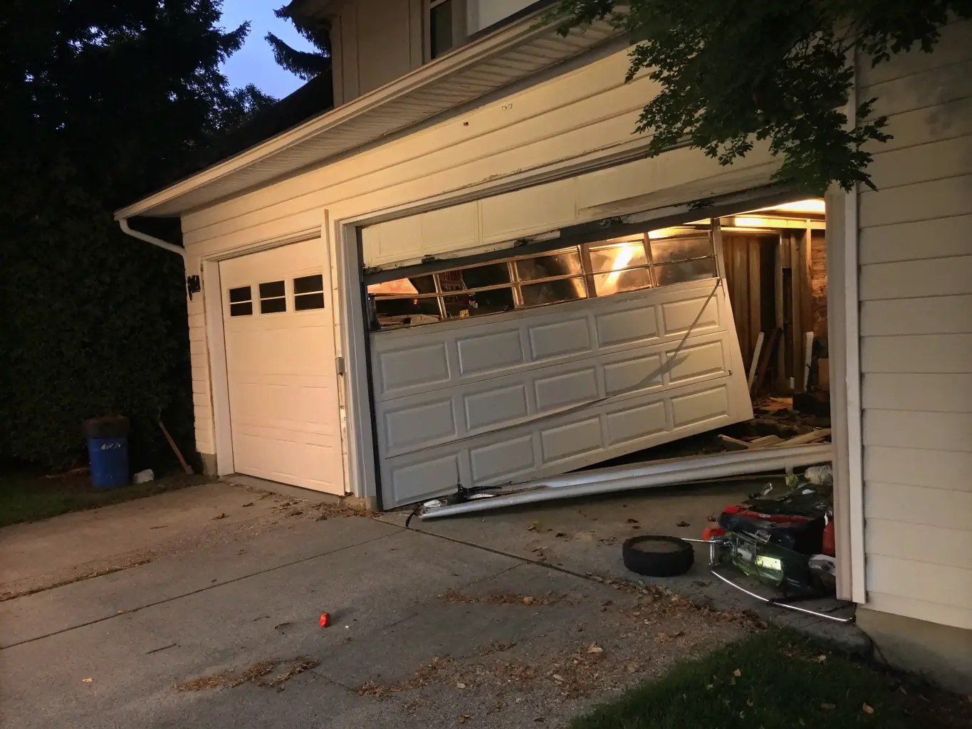 A damaged roller shutter slat and track, with visible dents and bends, illustrating the impact of physical damage on shutter functionality.